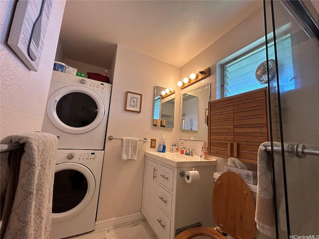 94-203 Paioa Pl Unit P201, Waipahu, HI 96797 - bathroom with stacked washer / dryer, vanity, a tile shower, a textured wall, and a textured ceiling
