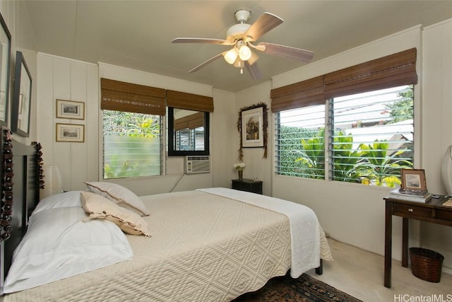 carpeted bedroom with multiple windows, cooling unit, and ceiling fan
