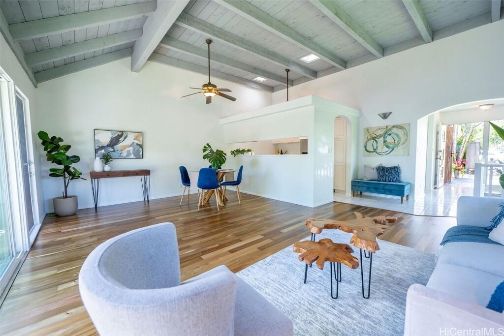 47-736 Hui Kelu St Unit 1101, Kaneohe, HI 96744 - living area featuring high vaulted ceiling, beamed ceiling, wood finished floors, a ceiling fan, and arched walkways
