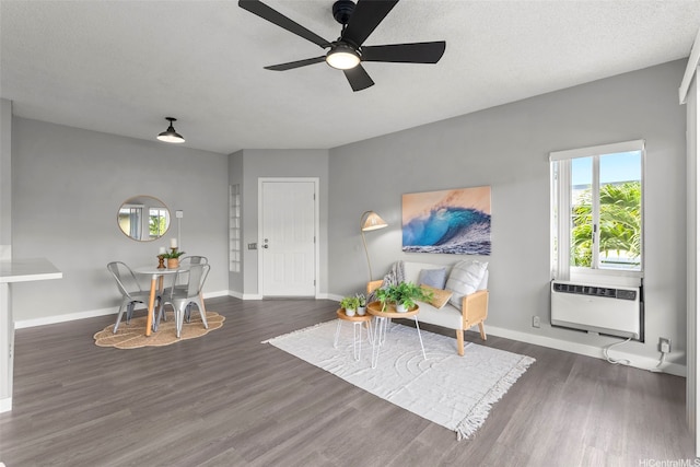 91-293 Hanapouli Cir Unit 3I, Ewa Beach, HI 96706 - living room featuring dark wood-style floors, a ceiling fan, and a wall unit AC