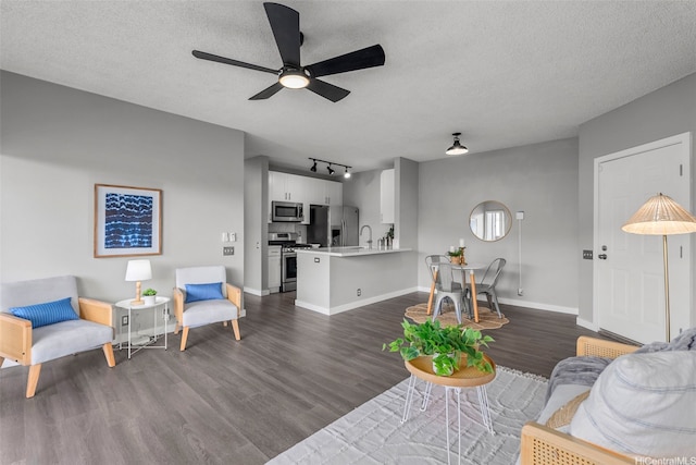 91-293 Hanapouli Cir Unit 3I, Ewa Beach, HI 96706 - living room featuring dark wood-type flooring, ceiling fan, a textured ceiling, and rail lighting