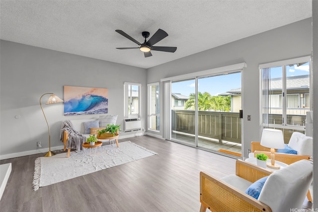 91-293 Hanapouli Cir Unit 3I, Ewa Beach, HI 96706 - living area with wood finished floors, a ceiling fan, and a textured ceiling