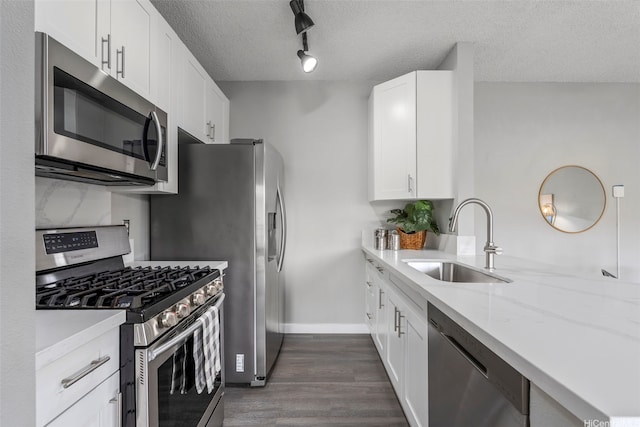 91-293 Hanapouli Cir Unit 3I, Ewa Beach, HI 96706 - kitchen with stainless steel appliances, dark wood-style floors, white cabinetry, a textured ceiling, and light stone counters