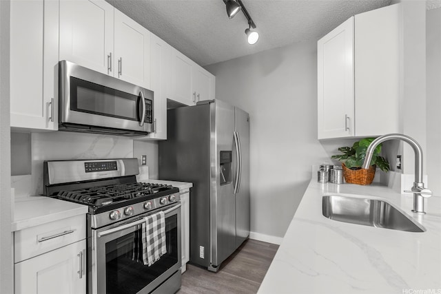 91-293 Hanapouli Cir Unit 3I, Ewa Beach, HI 96706 - kitchen with appliances with stainless steel finishes, light stone counters, a textured ceiling, and white cabinets