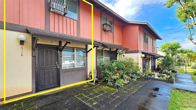 property entrance with stucco siding
