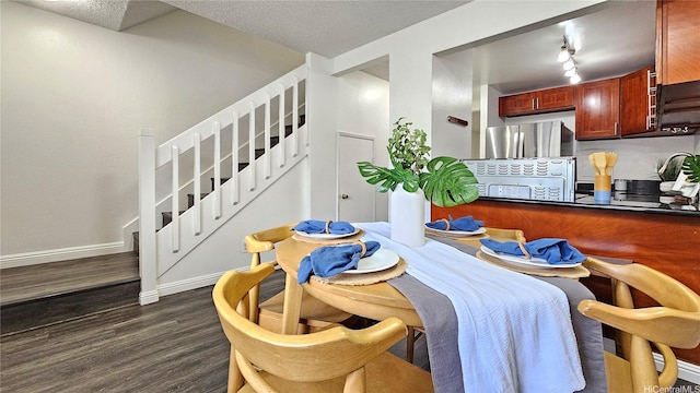 dining area with baseboards, track lighting, stairway, a textured ceiling, and dark wood-type flooring