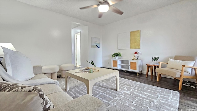 living room featuring baseboards, a ceiling fan, and wood finished floors