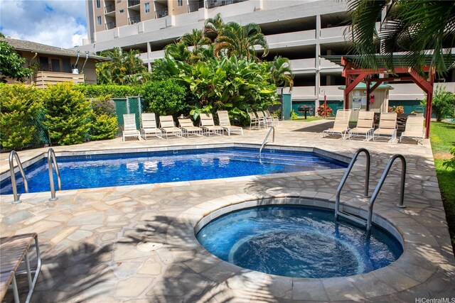 pool with a patio and a community hot tub