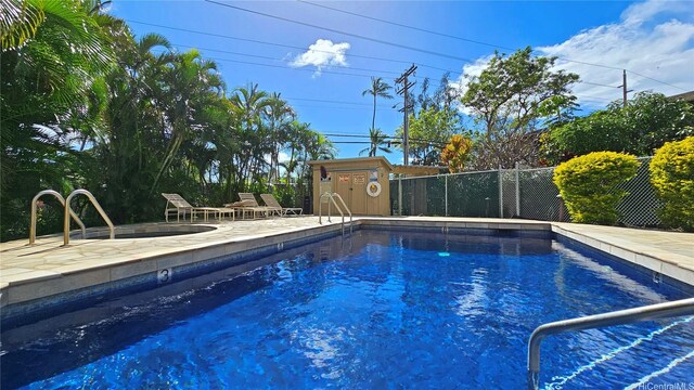 pool with a patio and a fenced backyard