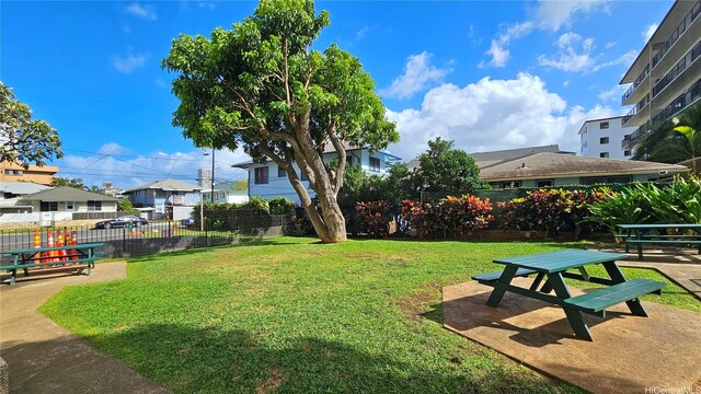 surrounding community featuring a residential view, fence, a patio, and a yard