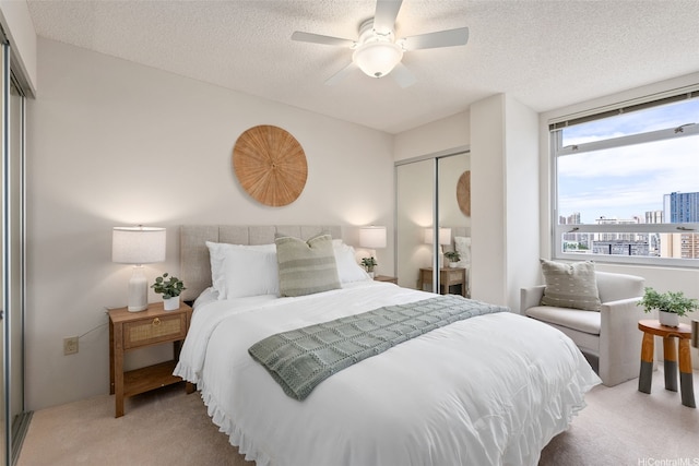 1315 Kalakaua Ave Unit 1903, Honolulu, HI 96826 - bedroom featuring light colored carpet, a closet, a textured ceiling, and ceiling fan