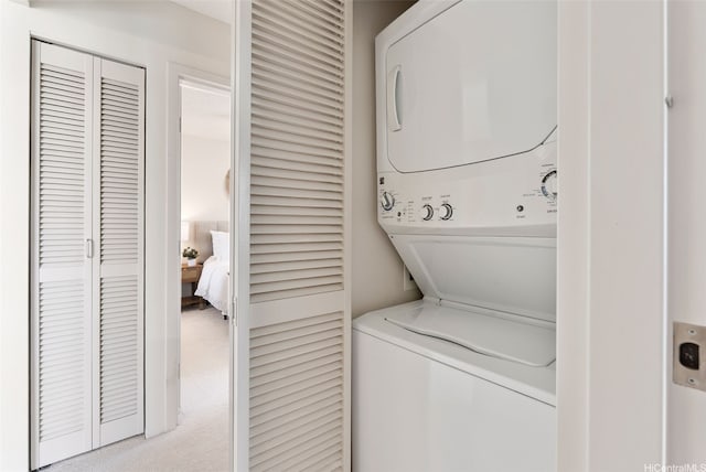 1315 Kalakaua Ave Unit 1903, Honolulu, HI 96826 - clothes washing area featuring stacked washing machine and dryer and carpet flooring