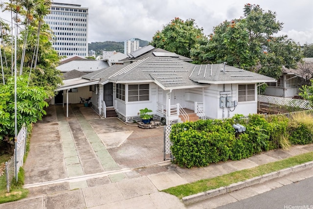bungalow-style house with concrete driveway and a shingled roof