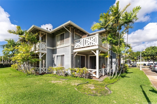91-1058 Kekuilani Loop Unit 1701, Kapolei, HI 96707 - back of property featuring a balcony and a yard