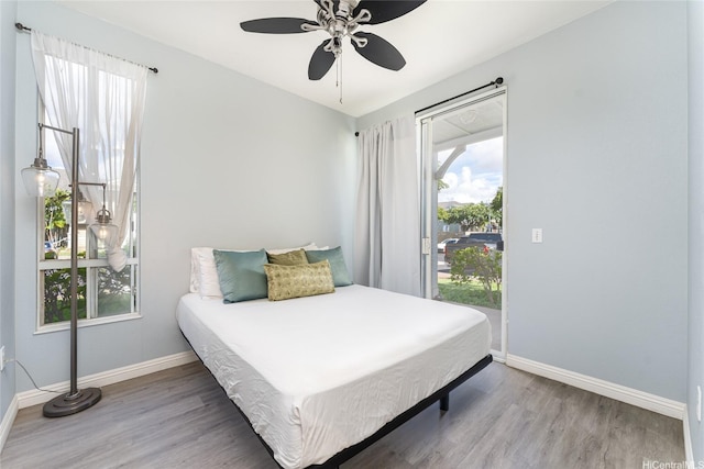 91-1058 Kekuilani Loop Unit 1701, Kapolei, HI 96707 - bedroom with wood finished floors, a ceiling fan, access to exterior, and baseboards