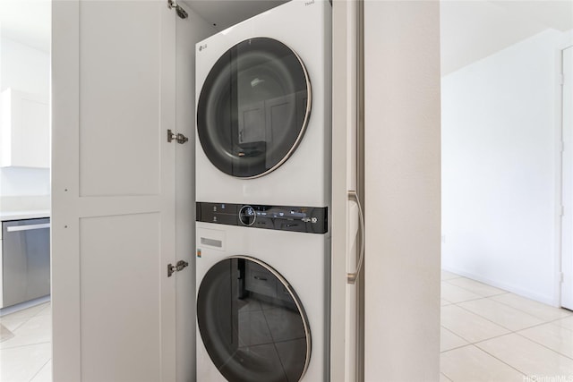 91-1058 Kekuilani Loop Unit 1701, Kapolei, HI 96707 - laundry room featuring light tile patterned floors, stacked washer / dryer, and laundry area
