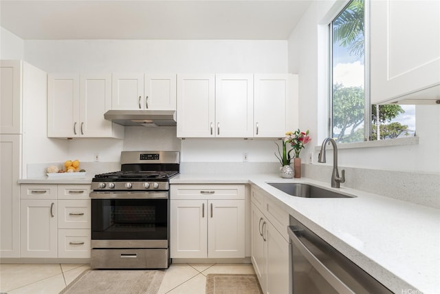 91-1058 Kekuilani Loop Unit 1701, Kapolei, HI 96707 - kitchen with stainless steel appliances, light tile patterned flooring, under cabinet range hood, and a sink