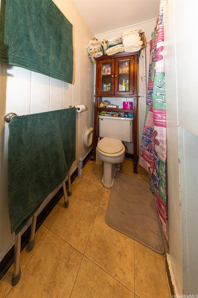 full bath featuring tile patterned flooring and toilet