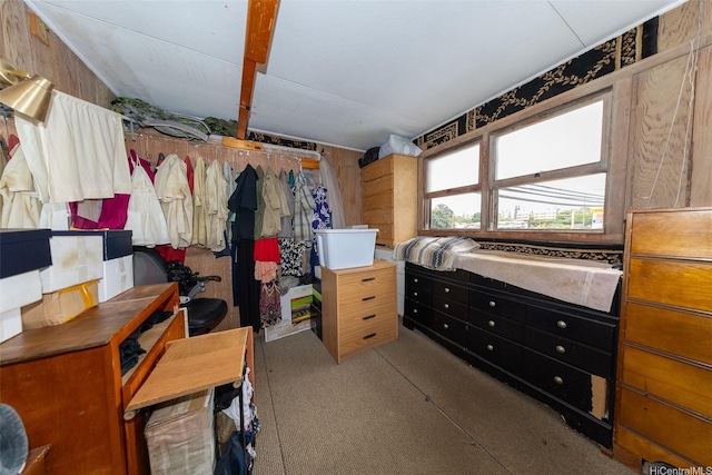 carpeted bedroom with wood walls