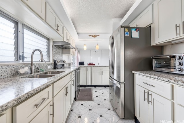 2421 Ala Wai Blvd Unit Ph1, Honolulu, HI 96815 - kitchen featuring a toaster, a sink, stainless steel appliances, under cabinet range hood, and a textured ceiling