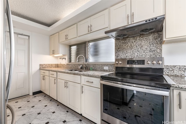 2421 Ala Wai Blvd Unit Ph1, Honolulu, HI 96815 - kitchen featuring under cabinet range hood, light stone counters, a sink, a textured ceiling, and appliances with stainless steel finishes
