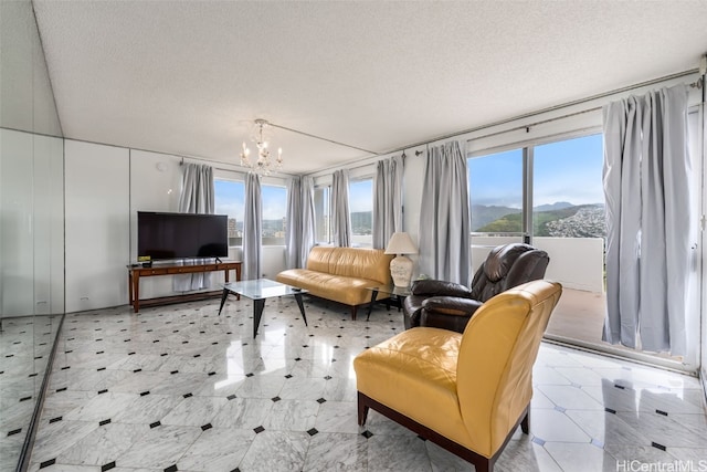 2421 Ala Wai Blvd Unit Ph1, Honolulu, HI 96815 - living room with plenty of natural light, a textured ceiling, and an inviting chandelier