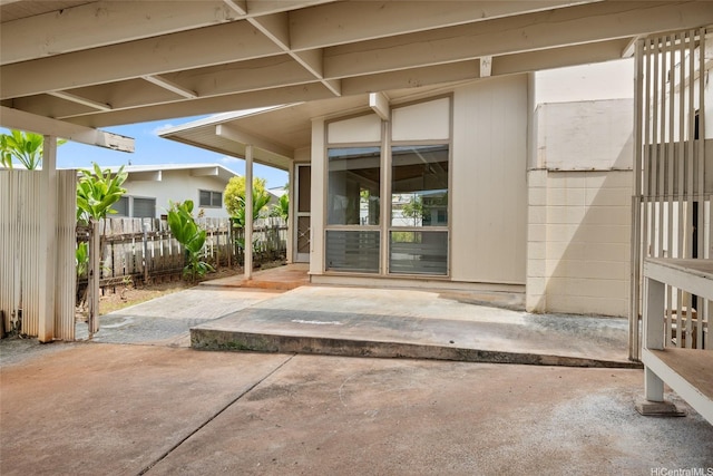 property entrance featuring a patio area and fence