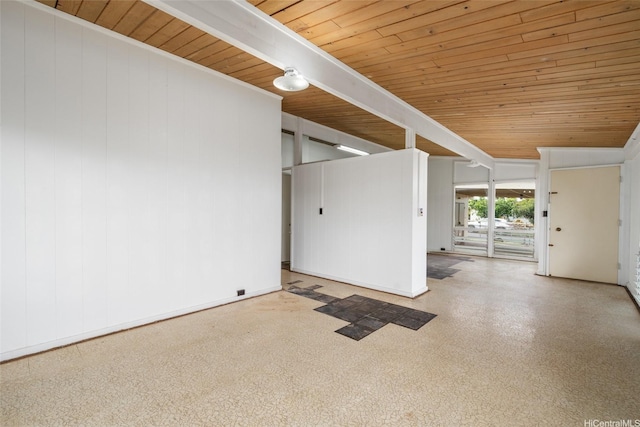 unfurnished room with wood ceiling and baseboards