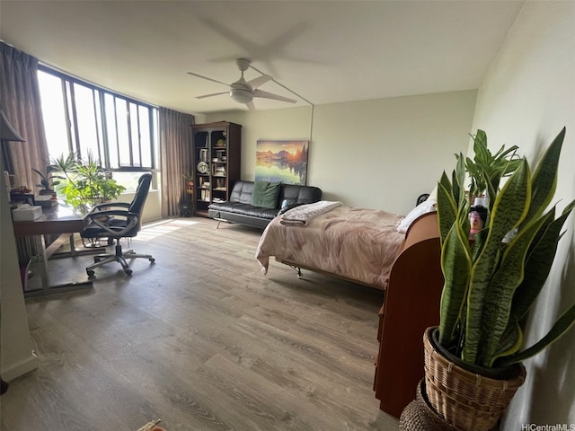 6770 Hawaii Kai Dr Unit 409, Honolulu, HI 96825 - bedroom with wood finished floors, a desk, and ceiling fan