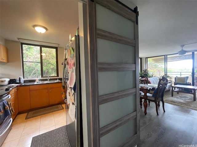 6770 Hawaii Kai Dr Unit 409, Honolulu, HI 96825 - kitchen featuring plenty of natural light, stainless steel appliances, dark countertops, and light tile patterned floors