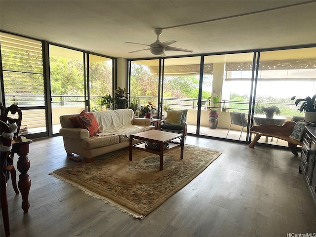 6770 Hawaii Kai Dr Unit 409, Honolulu, HI 96825 - living area with ceiling fan, expansive windows, wood finished floors, and healthy amount of natural light