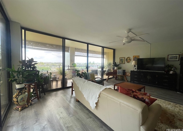 6770 Hawaii Kai Dr Unit 409, Honolulu, HI 96825 - living area with a wall of windows, ceiling fan, and wood finished floors