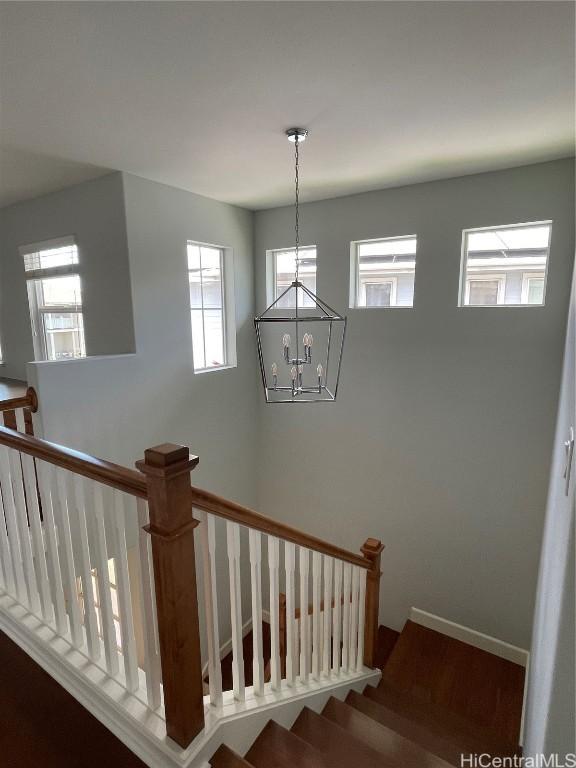 91-1510 Kaikohola St Unit D4, Ewa Beach, HI 96706 - stairway featuring baseboards, a notable chandelier, and wood finished floors