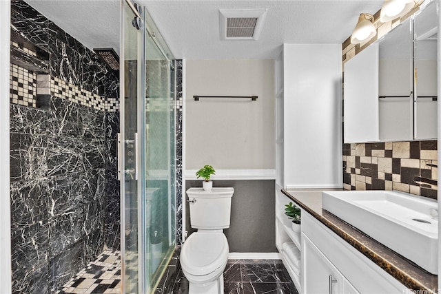 bathroom with a stall shower, backsplash, vanity, and toilet