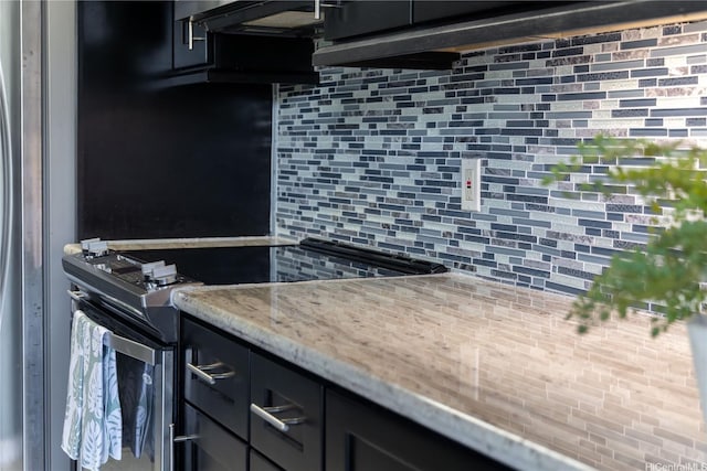 kitchen with stainless steel range with electric cooktop, backsplash, light stone counters, and range hood