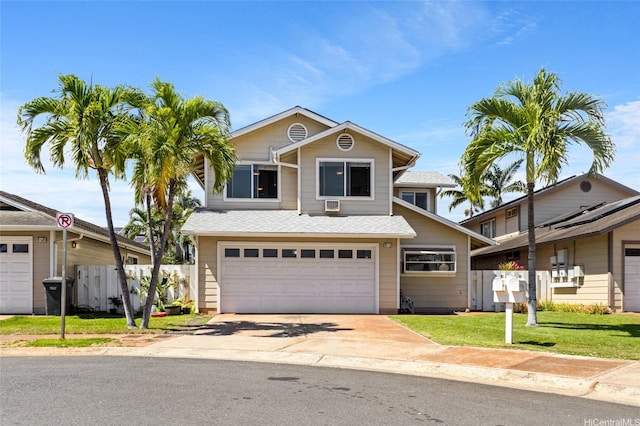 traditional-style house featuring a garage, a front lawn, fence, and concrete driveway
