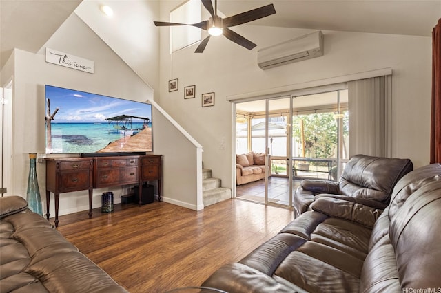 living area with ceiling fan, an AC wall unit, baseboards, wood finished floors, and stairway