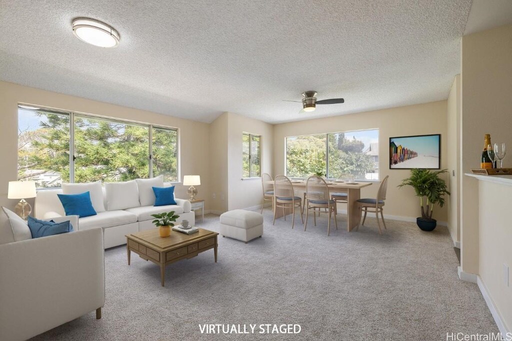 95-1165 Makaikai St Unit 212, Mililani, HI 96789 - living room featuring light carpet, a textured ceiling, baseboards, and ceiling fan