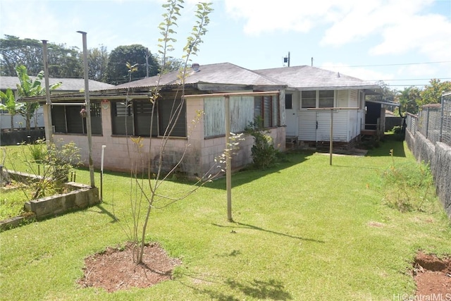 2354 California Ave, Wahiawa, HI 96786 - rear view of house with concrete block siding, a yard, and fence