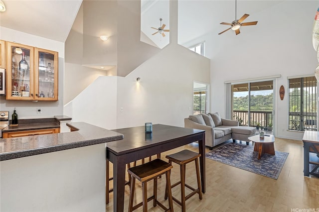 95-996 Wikao St Unit P302, Mililani, HI 96789 - interior space with light wood-style floors, ceiling fan, bar area, and high vaulted ceiling