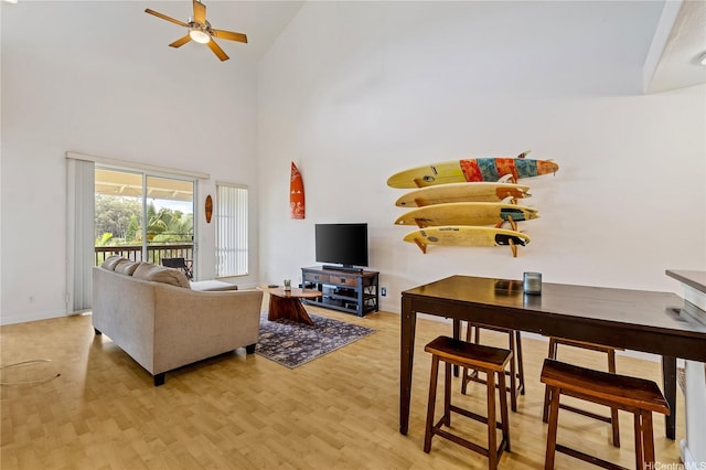 95-996 Wikao St Unit P302, Mililani, HI 96789 - living room featuring baseboards, ceiling fan, a high ceiling, and light wood-type flooring
