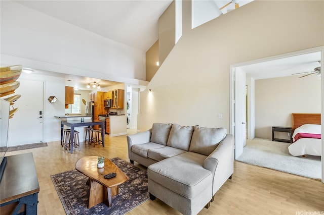 95-996 Wikao St Unit P302, Mililani, HI 96789 - living area featuring light wood-type flooring, a ceiling fan, and a towering ceiling