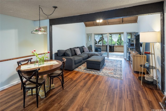 living room featuring baseboards, dark wood finished floors, and a textured ceiling