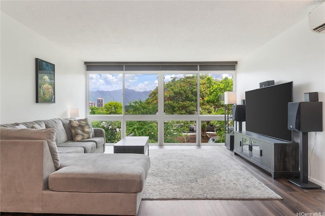 217 Prospect St Unit 106, Honolulu, HI 96813 - living area with a wall mounted AC, dark wood-style floors, expansive windows, and a textured ceiling