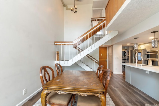 217 Prospect St Unit 106, Honolulu, HI 96813 - dining room featuring estacked washer and dryer, dark wood-style floors, baseboards, and stairway
