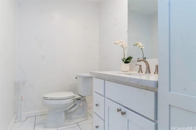 half bath with baseboards, toilet, vanity, and tile patterned floors
