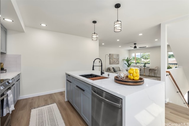 kitchen with a sink, gray cabinetry, electric stove, and dishwasher