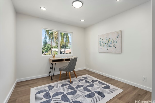 home office featuring baseboards, wood finished floors, and recessed lighting