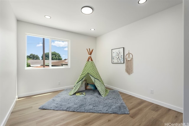 rec room with recessed lighting, baseboards, and wood finished floors