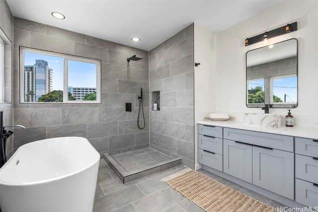 full bath featuring vanity, walk in shower, and plenty of natural light